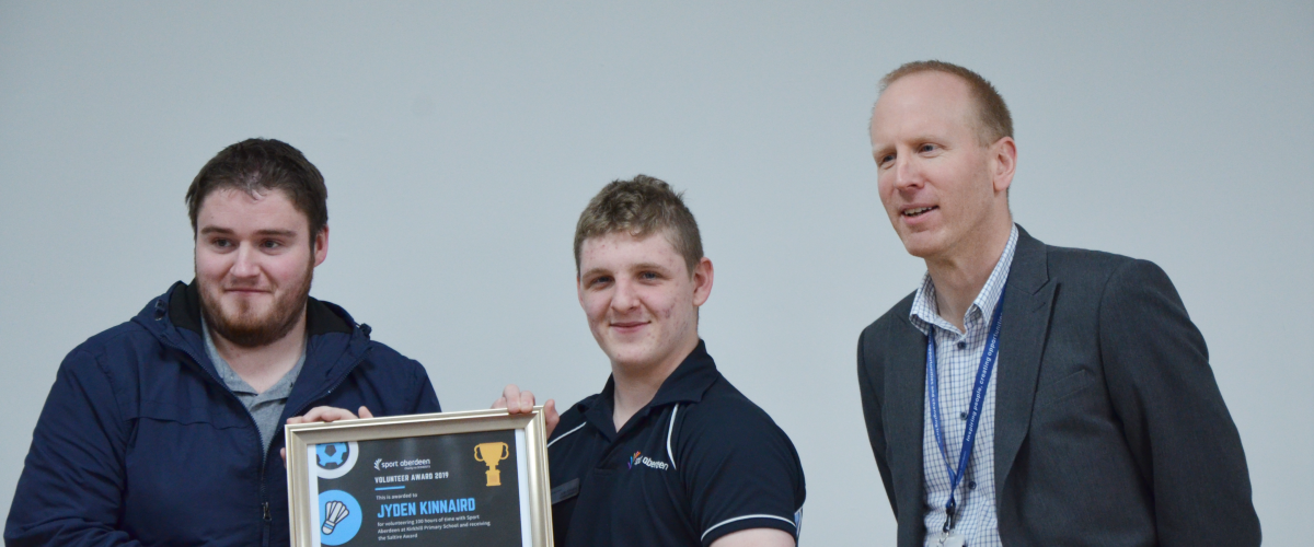 SPACE participant Jyden at a presentation for his volunteering achievements